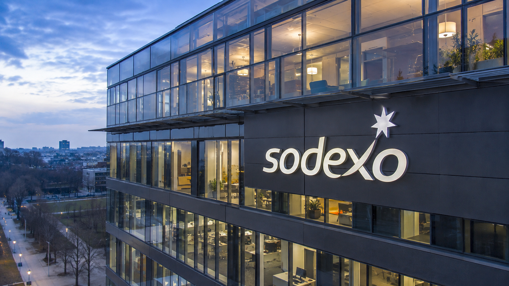 Bâtiment de bureaux Sodexo avec le logo du groupe sur la façade, illustrant le projet de restructuration et les 1 097 suppressions de postes prévues en France en 2026.
